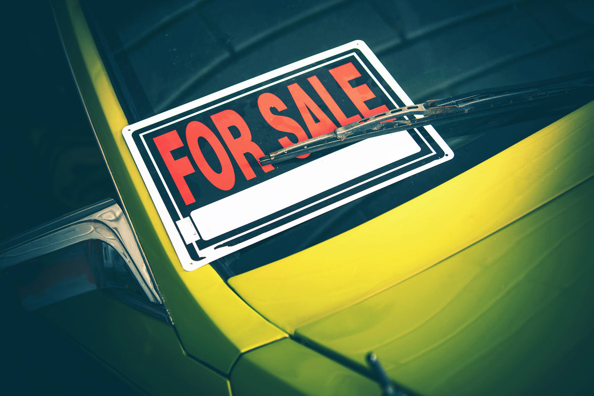 Green Vehicle With For Sale Sign on Windscreen
