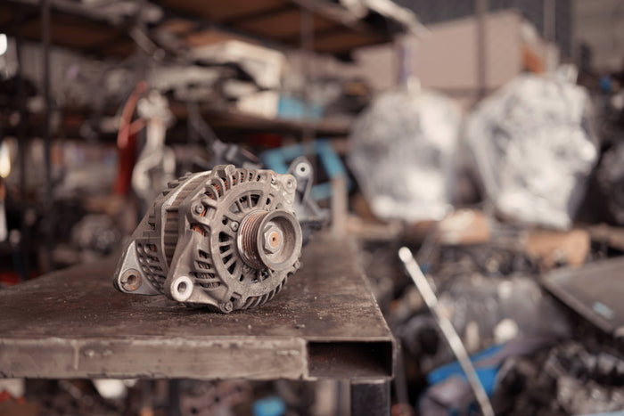 Alternator on a workbench removed from a vehicle